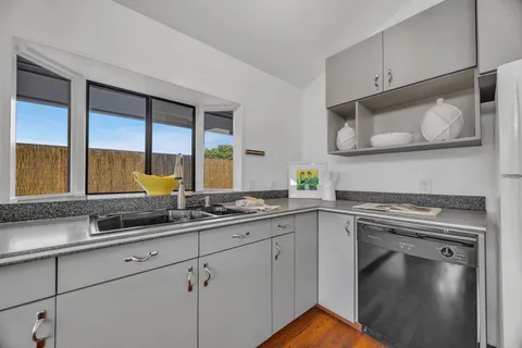 a kitchen with granite countertop cabinets stainless steel appliances and a sink