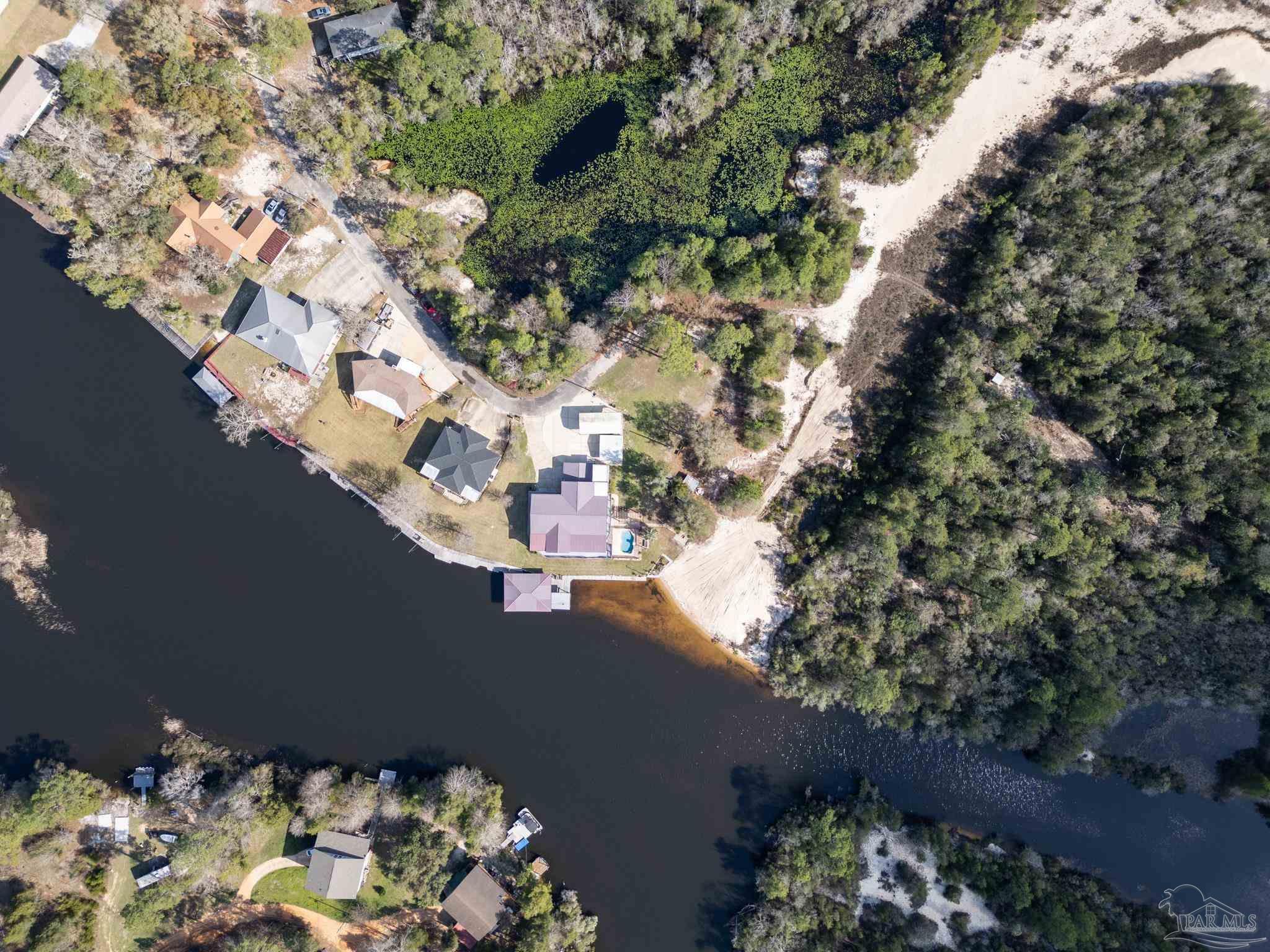 7608 River Road Milton, FL 32583 - Photo 7 of 28 a view of a house with a tree in the background