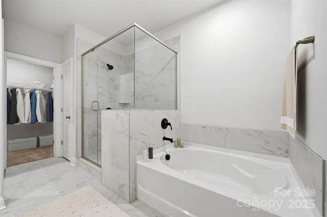 a view of a hallway with wooden floor and entryway