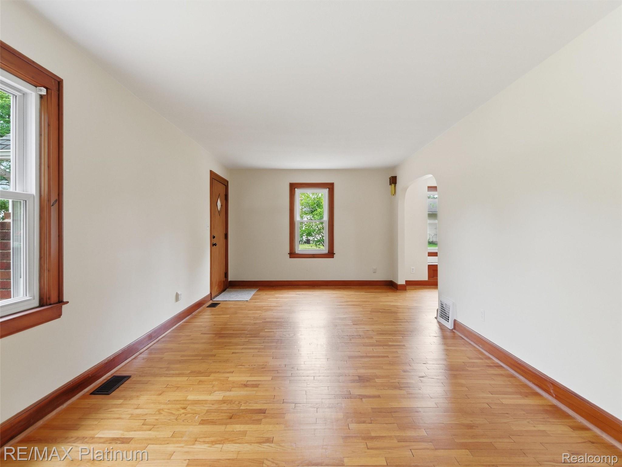 6335 Silver Lake Road Linden, MI 48451 - Photo 7 of 61 Bright interior featuring wood-finish flooring, white walls, and rich wood trim