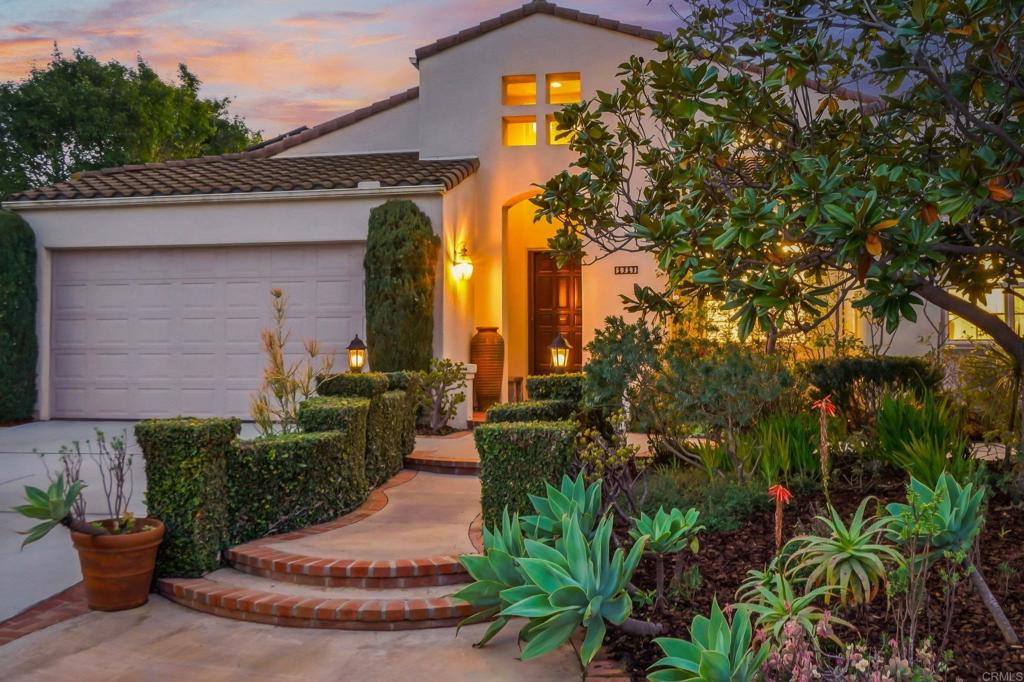 a view of a house with potted plants