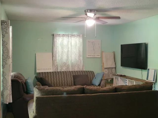a living room with furniture and a flat screen tv