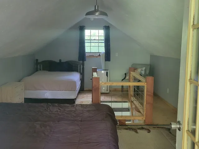 a bedroom with a bed and window