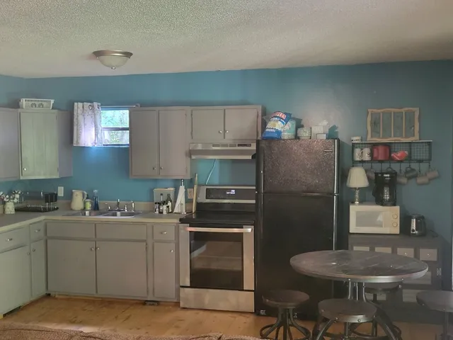 a kitchen with a sink cabinets and appliances