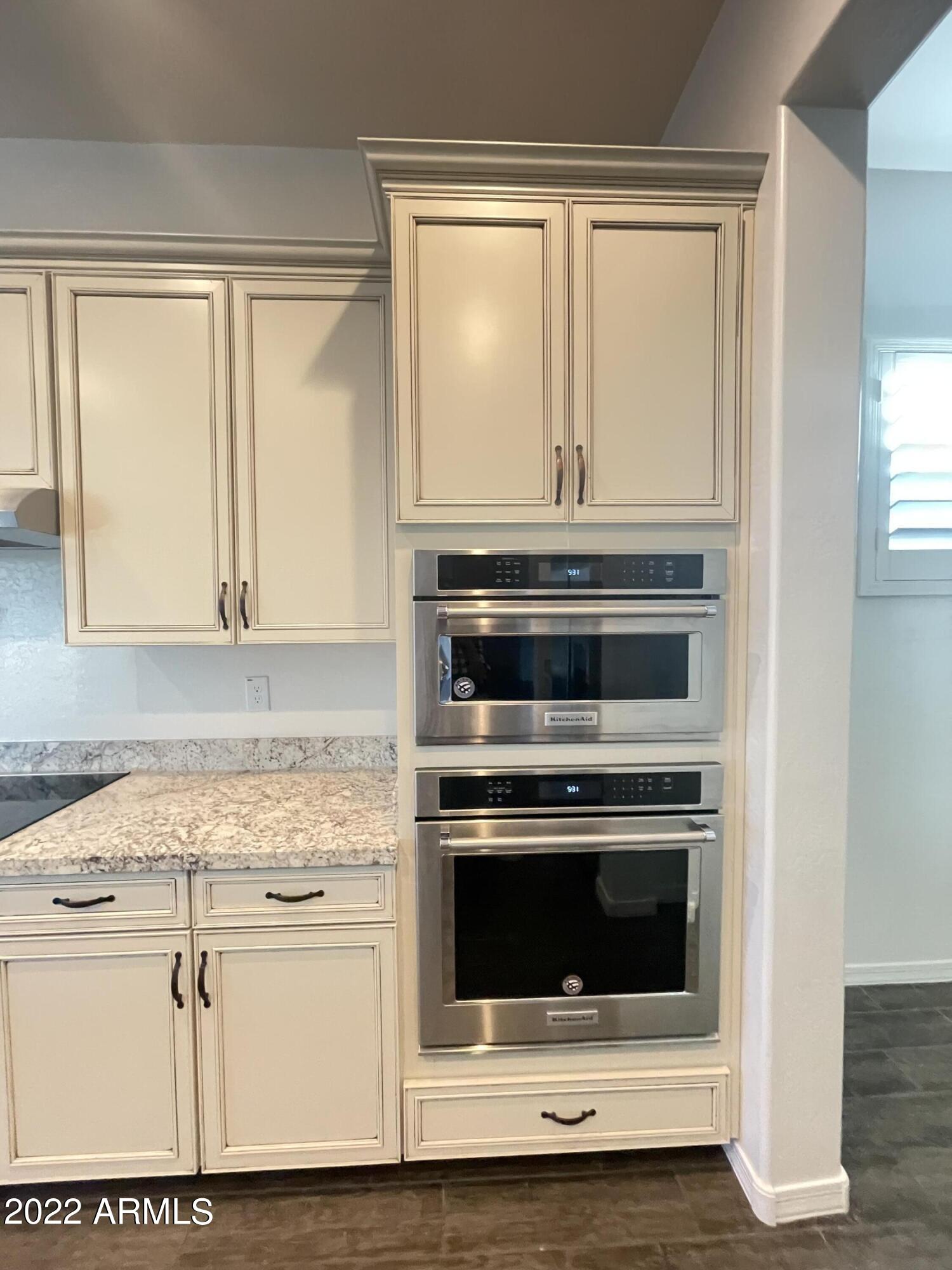 991 East Hampton Lane Gilbert, AZ 85295 - Photo 12 of 13 a kitchen with wooden floor and white stainless steel appliances