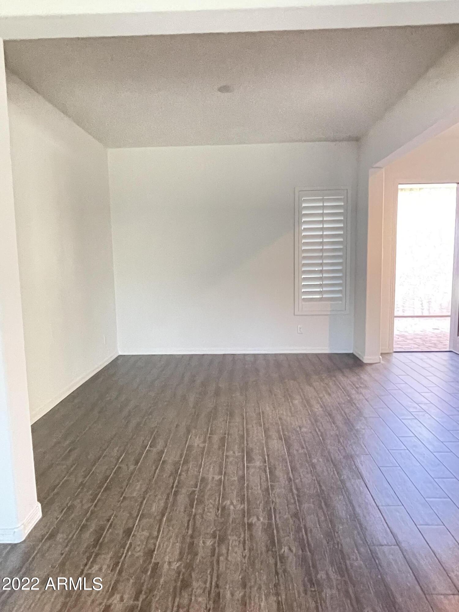 991 East Hampton Lane Gilbert, AZ 85295 - Photo 6 of 13 an empty room with wooden floor and windows