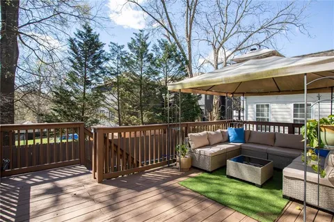 a view of a roof deck with wooden floor and fence