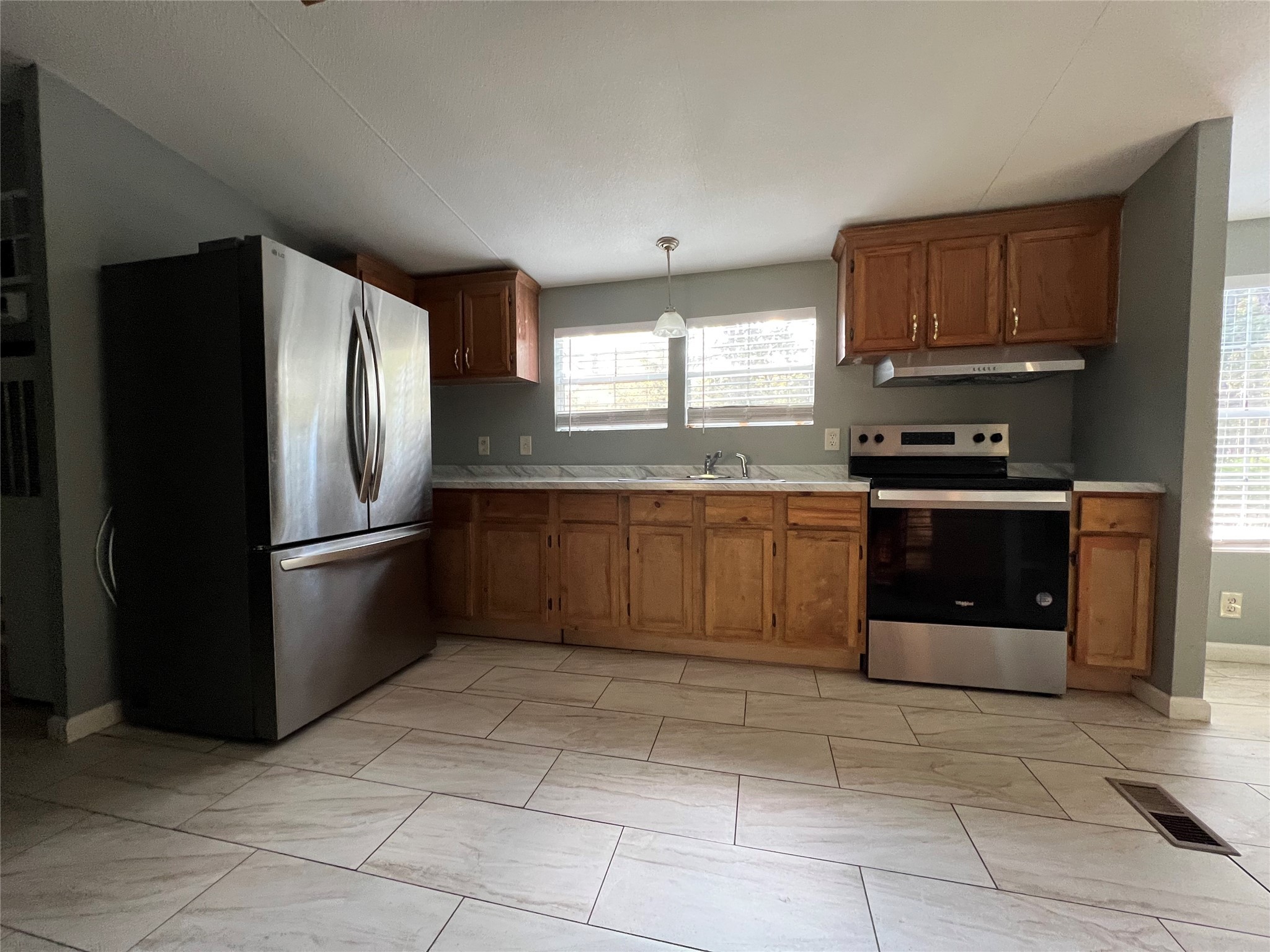 66 McFaddin Road Huntsville, TX 77340 - Photo 17 of 22 a kitchen with stainless steel appliances granite countertop a stove a refrigerator and a sink