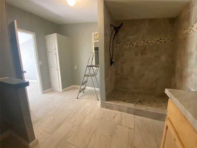 a bathroom with a toilet and a shower