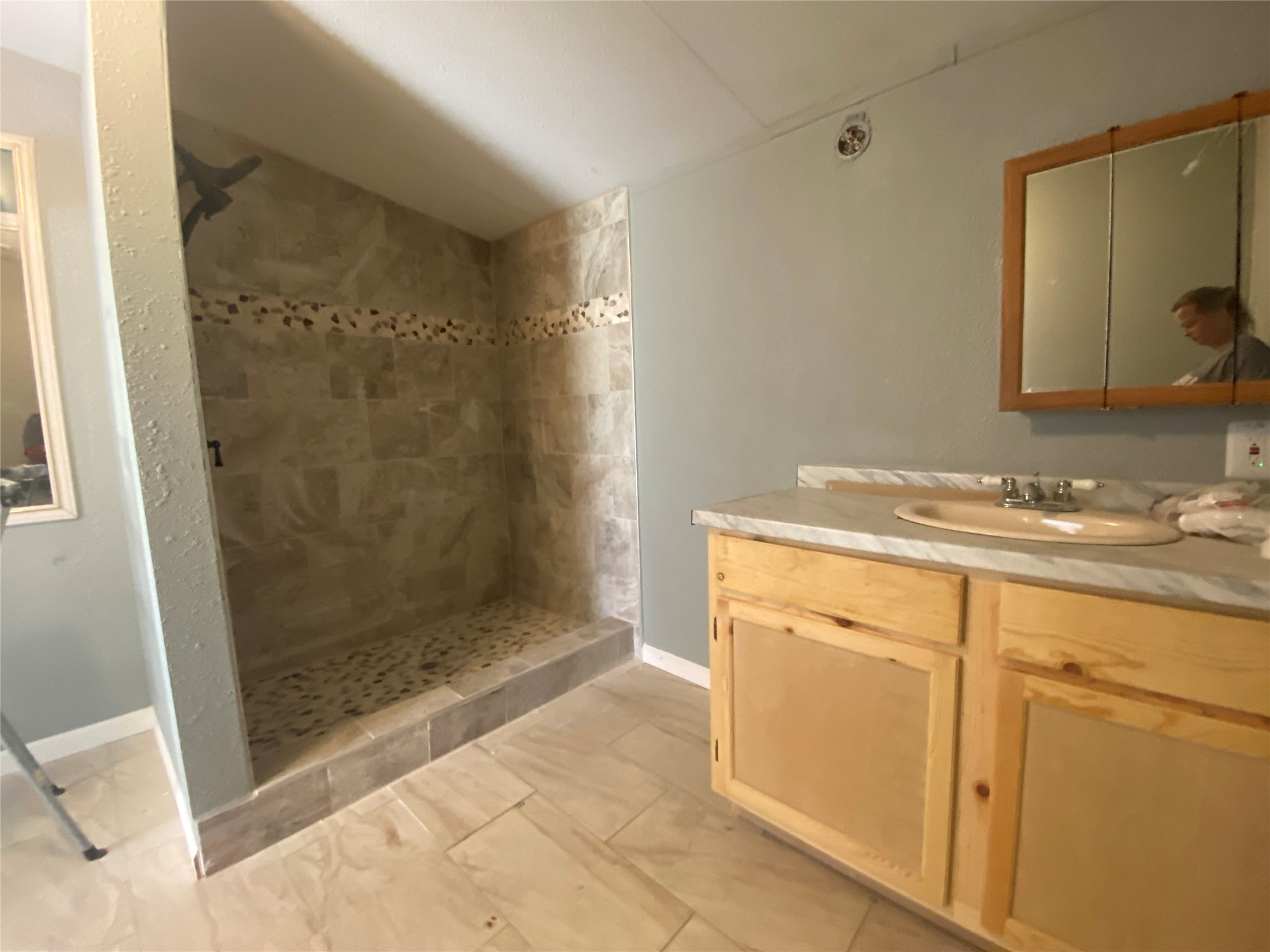 66 McFaddin Road Huntsville, TX 77340 - Photo 21 of 22 a bathroom with a shower sink and mirror
