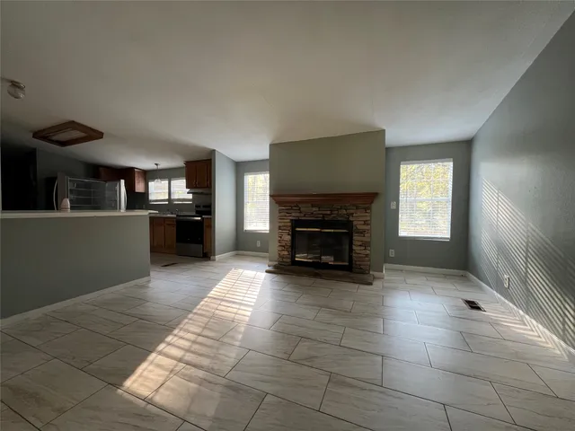 a view of a livingroom with a fireplace and window