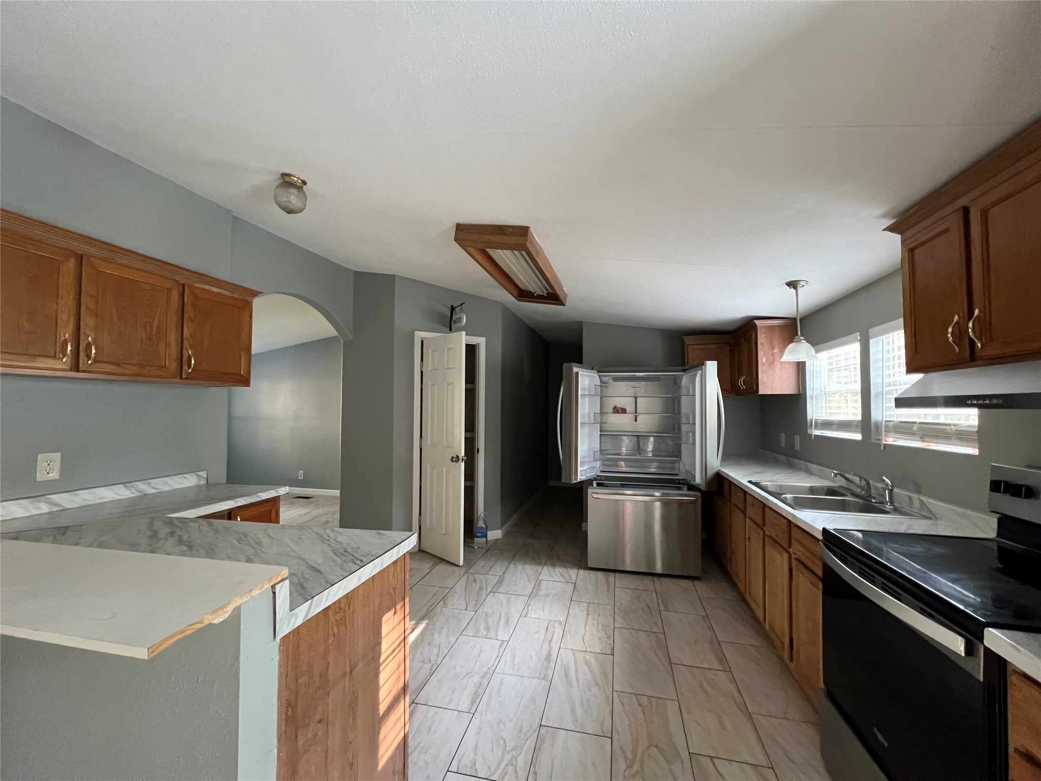 66 McFaddin Road Huntsville, TX 77340 - Photo 4 of 22 a kitchen with stainless steel appliances granite countertop a sink stove and refrigerator