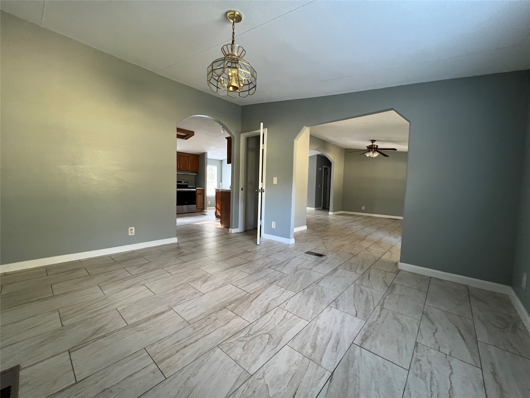 66 McFaddin Road Huntsville, TX 77340 - Photo 10 of 22 a view of a hallway with wooden floor and a chandelier