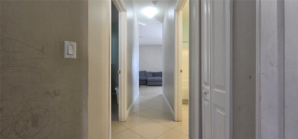 10927 Leader Lane Orlando, FL 32825 - Photo 15 of 29 a view of a bathroom from a corridor