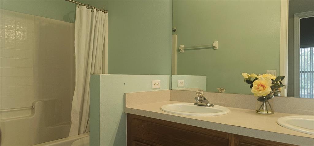 10927 Leader Lane Orlando, FL 32825 - Photo 16 of 29 a bathroom with a sink and a mirror