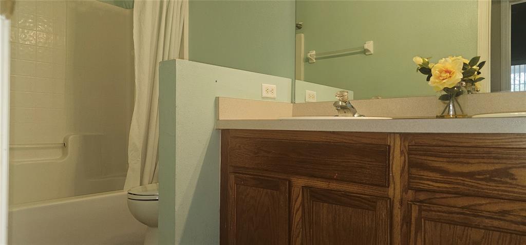 10927 Leader Lane Orlando, FL 32825 - Photo 17 of 29 a bathroom with a sink and mirror