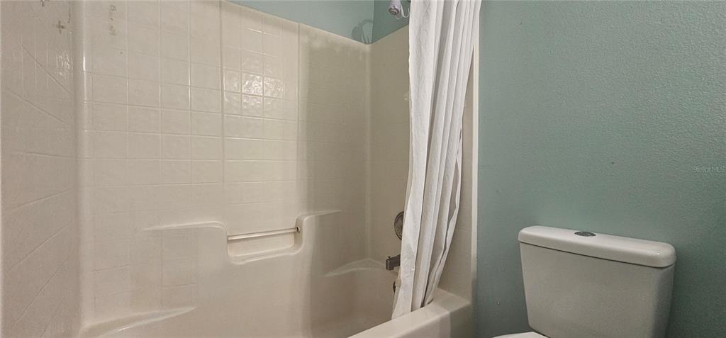 10927 Leader Lane Orlando, FL 32825 - Photo 18 of 29 a bathroom with a shower and toilet