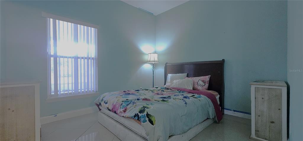 10927 Leader Lane Orlando, FL 32825 - Photo 19 of 29 a bedroom with a bed and a window