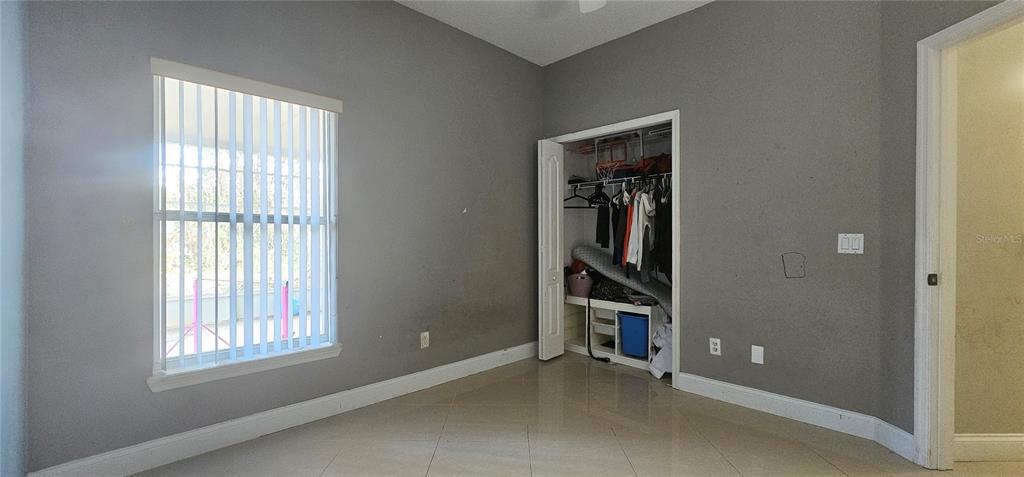 10927 Leader Lane Orlando, FL 32825 - Photo 22 of 29 an empty room with windows and closet
