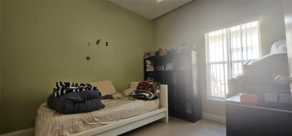10927 Leader Lane Orlando, FL 32825 - Photo 23 of 29 a bedroom with a bed and a window