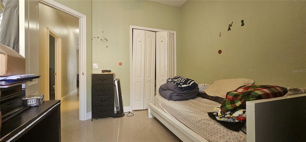 10927 Leader Lane Orlando, FL 32825 - Photo 24 of 29 a bedroom with a bed and a dresser