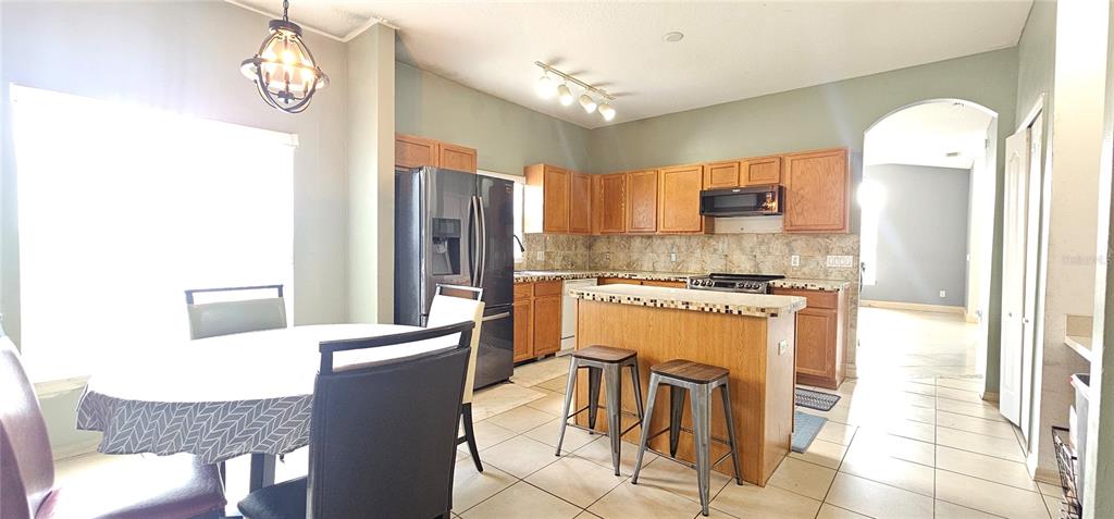 10927 Leader Lane Orlando, FL 32825 - Photo 7 of 29 a kitchen with stainless steel appliances granite countertop a refrigerator a stove and a sink