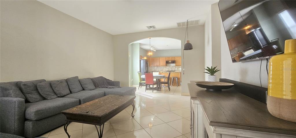 10927 Leader Lane Orlando, FL 32825 - Photo 10 of 29 a living room with furniture and a flat screen tv