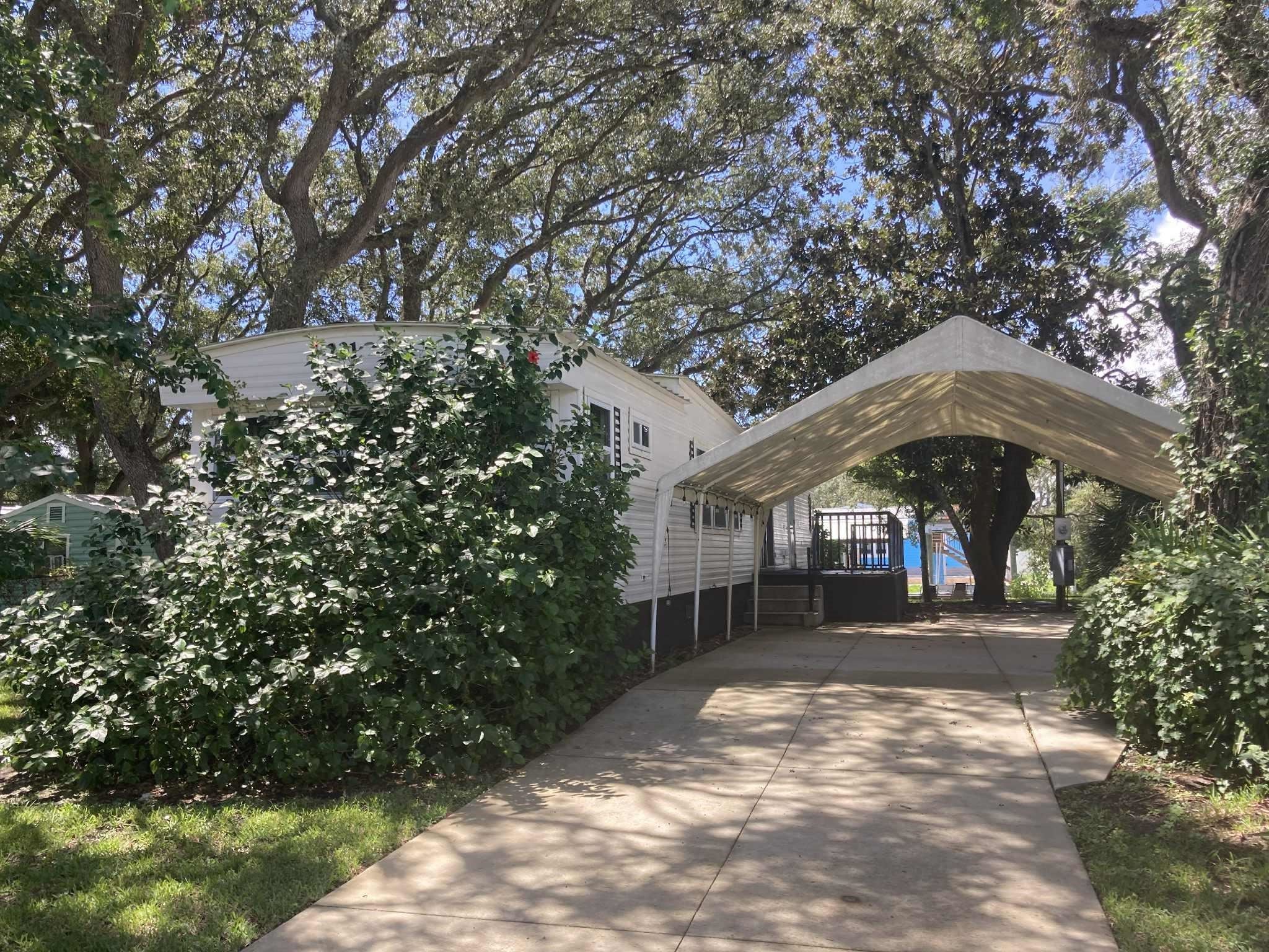 231 Puebla Road St. Augustine, FL 32080 - Photo 3 of 54 View of parking featuring a detached carport and concrete driveway