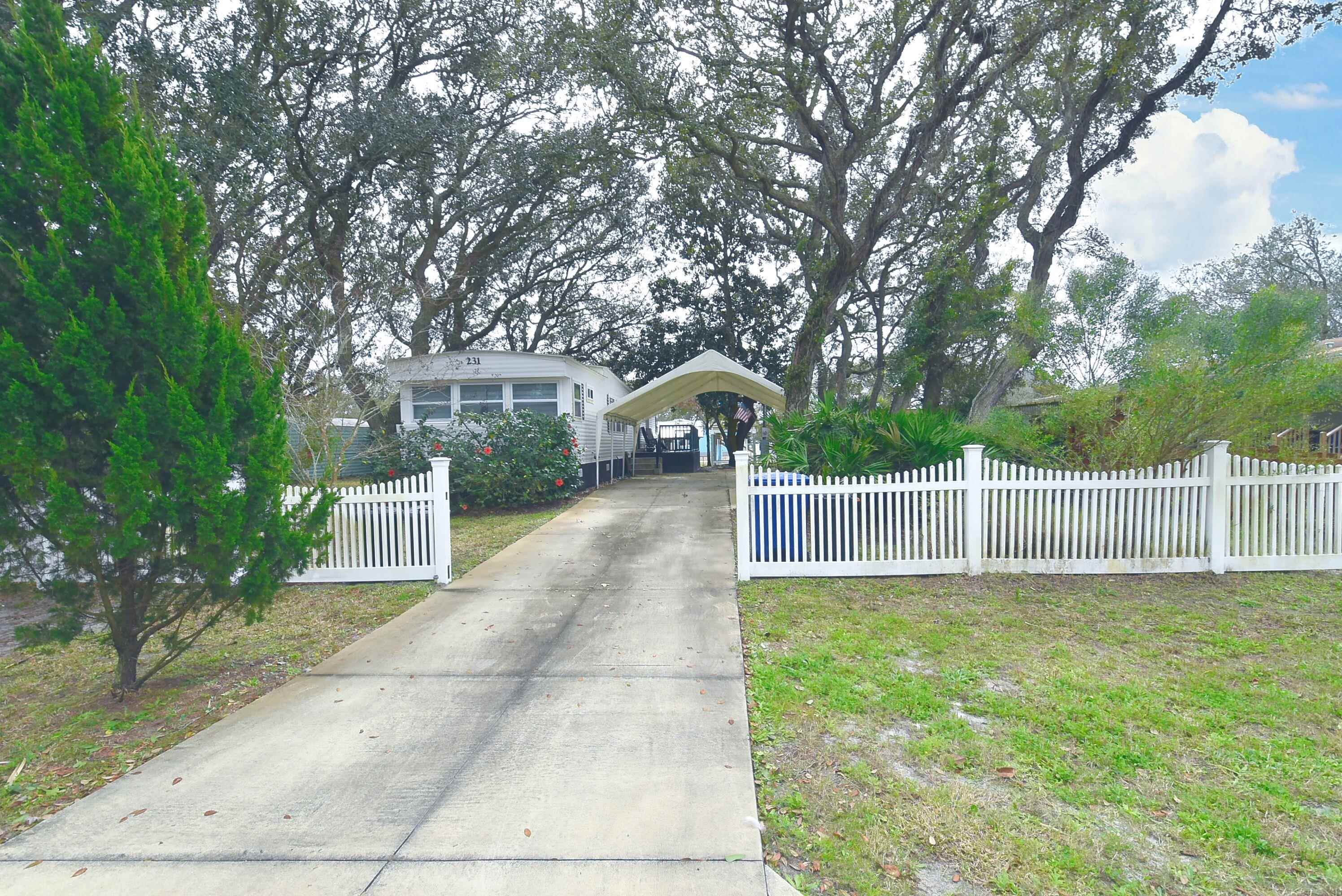 231 Puebla Road St. Augustine, FL 32080 - Photo 36 of 54 Bungalow featuring a fenced front yard, concrete driveway, and a carport