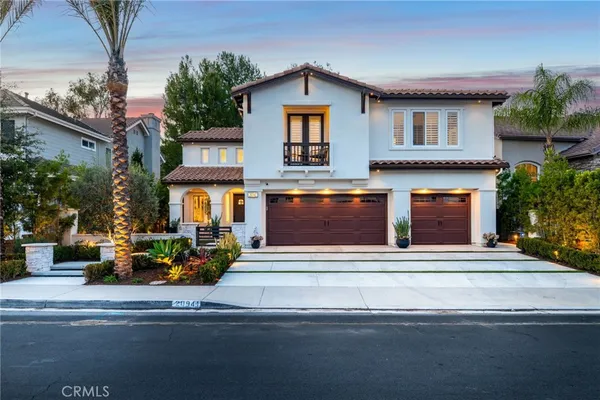 a front view of a house with a fountain and a fire pit