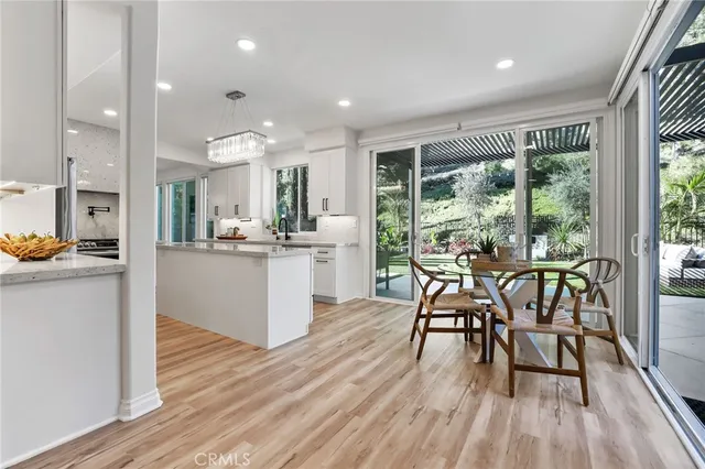a large kitchen with stainless steel appliances lots of counter space and a sink