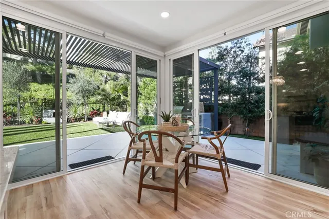 a large white kitchen with a large window and stainless steel appliances
