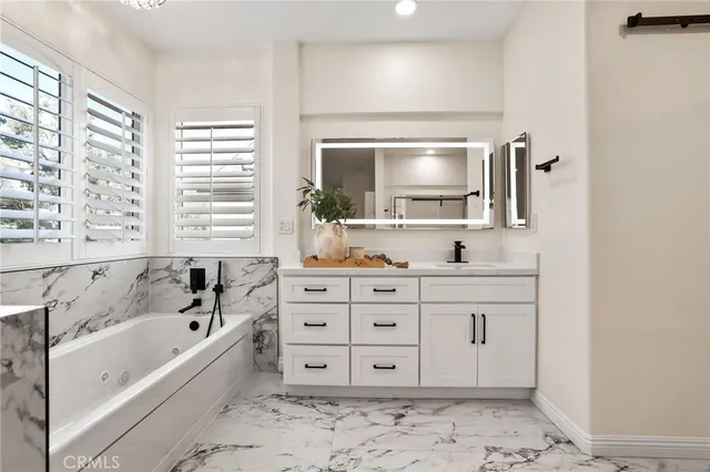 a bedroom with furniture and a large window