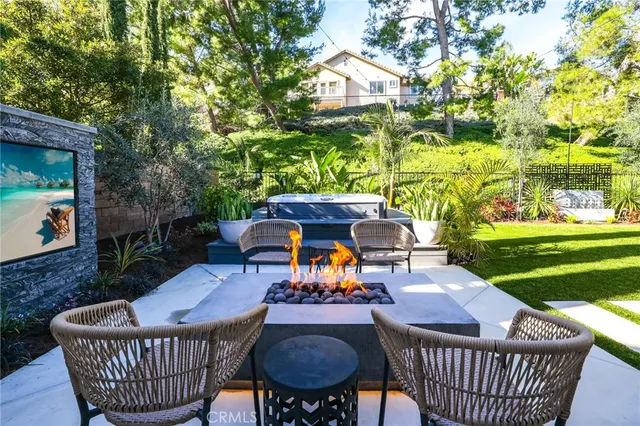 a view of a patio with couches table and chairs and garden