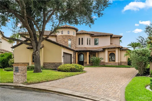 a front view of a house with a garden and plants