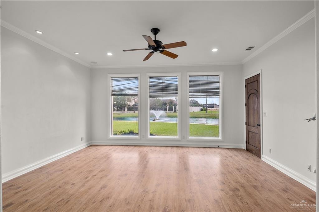 4405 South "H" Street McAllen, TX 78503 - Photo 12 of 33 a view of an empty room with a window and wooden floor