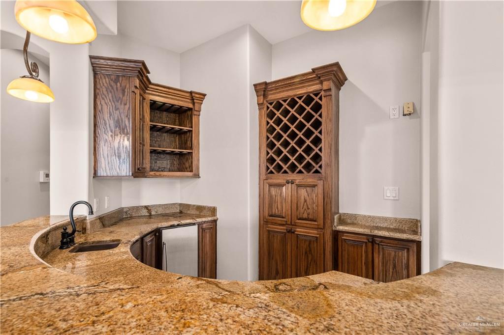 4405 South "H" Street McAllen, TX 78503 - Photo 17 of 33 a kitchen with stainless steel appliances granite countertop a sink stove and refrigerator