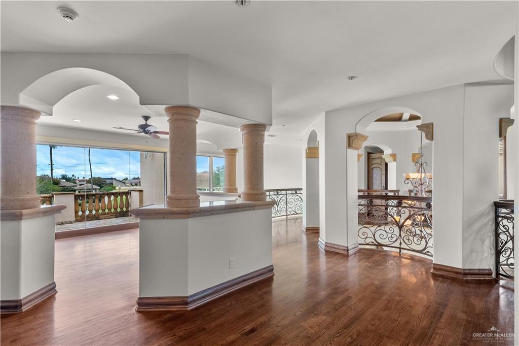 4405 South "H" Street McAllen, TX 78503 - Photo 21 of 33 a kitchen with stainless steel appliances granite countertop a stove and cabinets with wooden floor