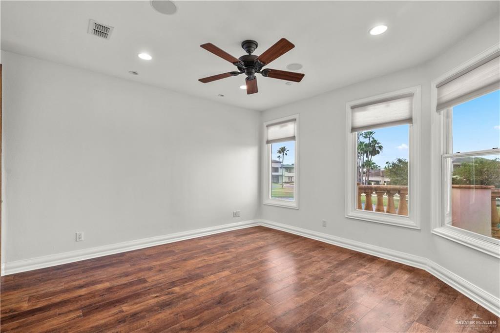 4405 South "H" Street McAllen, TX 78503 - Photo 23 of 33 an empty room with wooden floor windows and fan