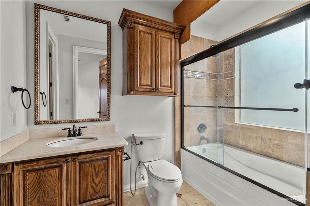 4405 South "H" Street McAllen, TX 78503 - Photo 24 of 33 a bathroom with a granite countertop sink toilet and shower