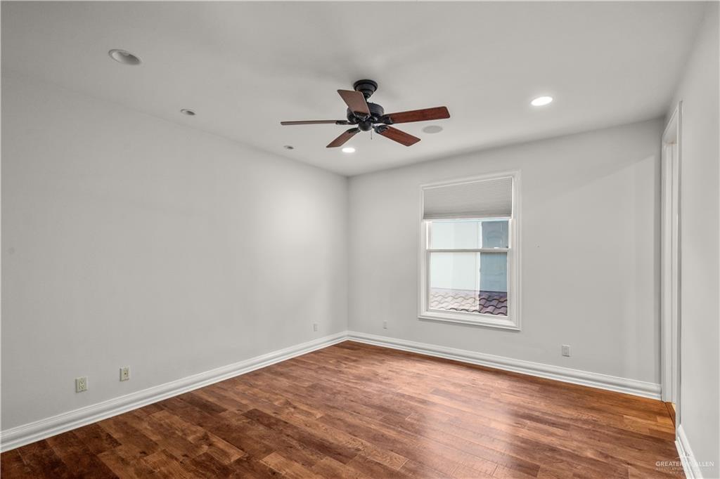 4405 South "H" Street McAllen, TX 78503 - Photo 25 of 33 wooden floor in an empty room with a window