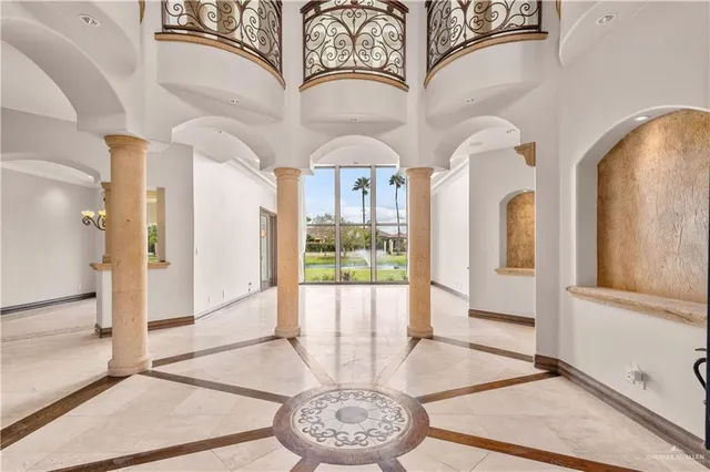 a view of a hallway with wooden floor and a dining space