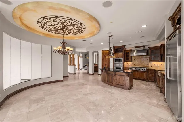 a view of a kitchen with a sink and a large window