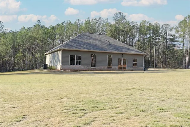a house view with swimming pool in front of it