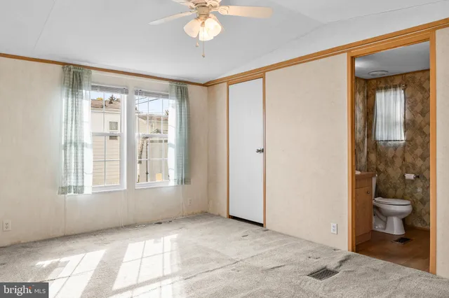 a view of a bedroom with a large window and wooden floor