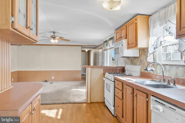 a kitchen with stainless steel appliances granite countertop a sink and a stove