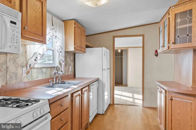 a kitchen with stainless steel appliances granite countertop a refrigerator and a stove