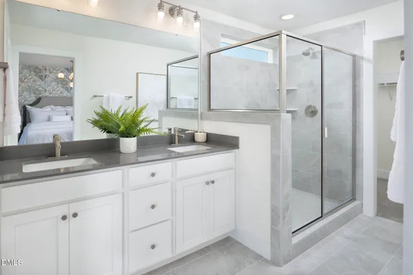 a bathroom with a shower sink and mirror