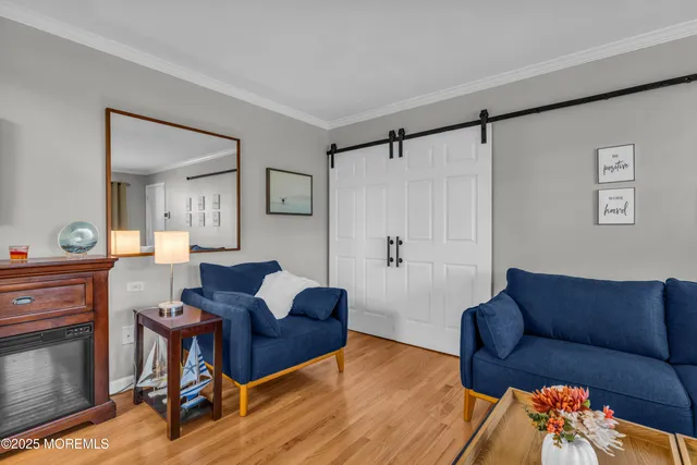 a living room with furniture a ceiling fan and a wooden floor