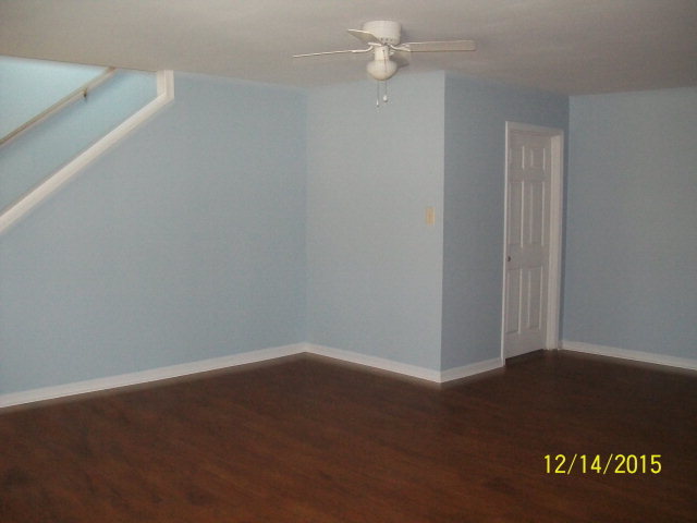 500 Huckabee Road Gray, GA 31032 - Photo 13 of 17 an empty room with a ceiling fan and wooden floor